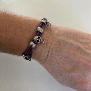 Purple leather skull bracelet.